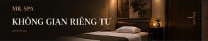 Ảnh minh họa phòng spa đơn với giường massage, khăn gọn và đèn ánh vàng.
